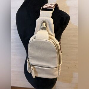 Urban Expressions Liberty leather sling bag with a chevron pattern strap.